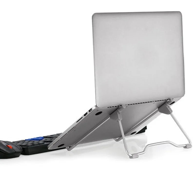 Grey aluminium alloy adjustable stand holding a mobile phone and a laptop at an angle.