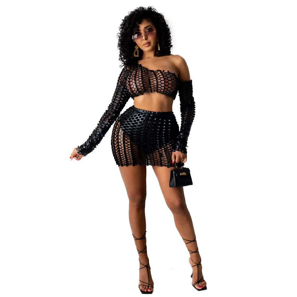 Women's black hollow-out two-piece dress set with sleeveless top and short skirt.