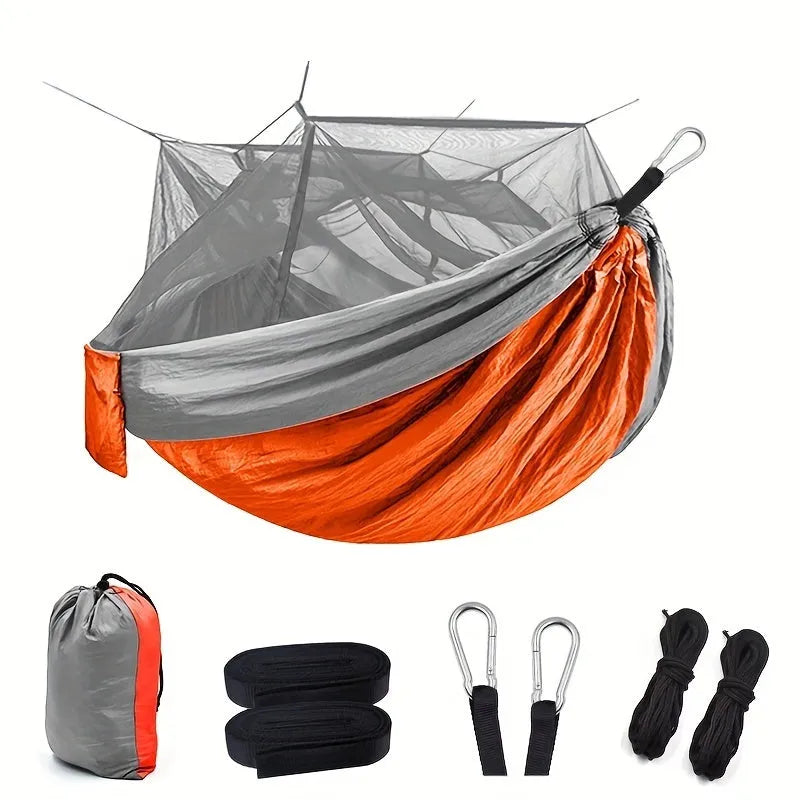 Portable double camping hammock with mosquito net and tree straps in outdoor setting