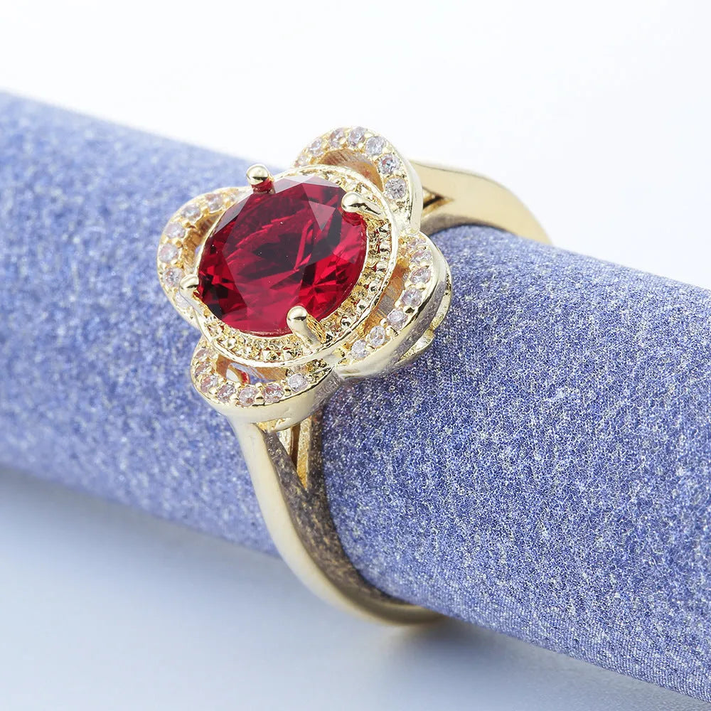 Copper fruit-shaped ring with a central zircon inlay on a model's finger.