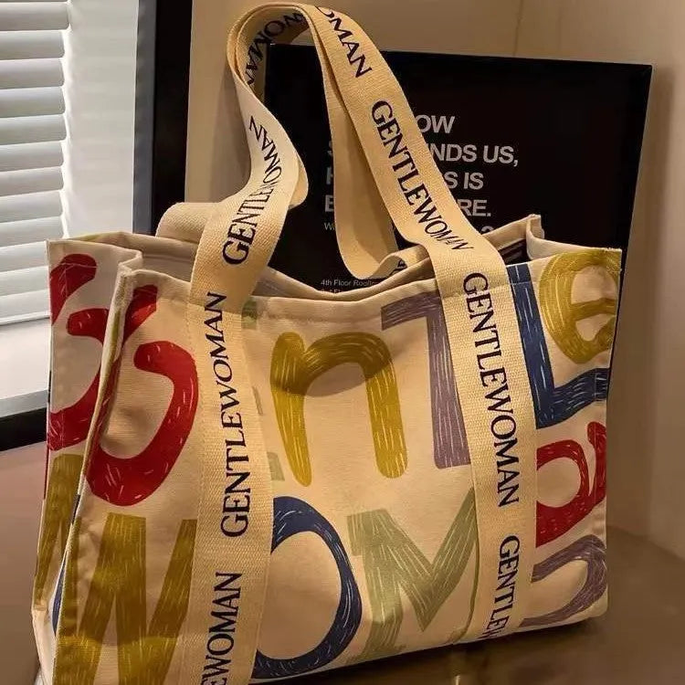 Large canvas tote bag with printed design, showing substantial capacity and casual styling