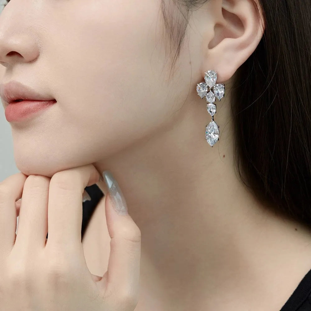 Pair of S925 sterling silver drop-shaped stud earrings with Platinum White Diamond electroplated finish on white background