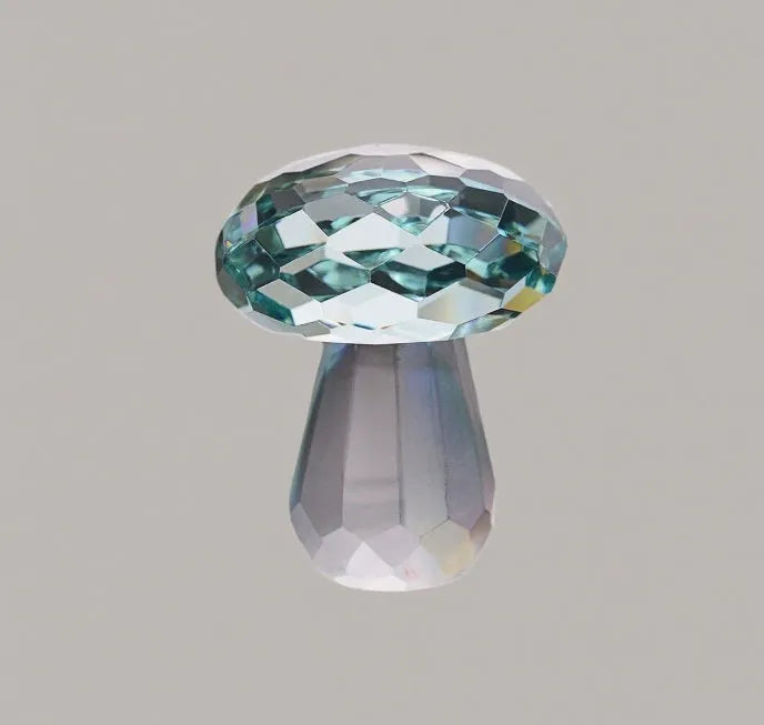 Colourful white crystal mushroom decorative craft in modern geometric style on a desk.