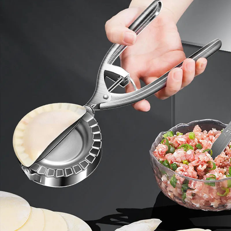 Silver stainless steel manual dumpling maker mould with handle for pressing and cutting wrappers.