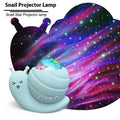 Snail-shaped starry sky projection lamp in blue with USB cable and remote control on a table.
