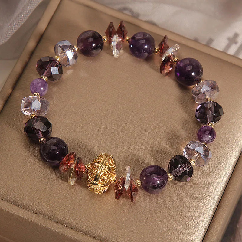 Purple crystal bracelet with pumpkin beads, wind chime motifs, and rhinestone decorations on adjustable band