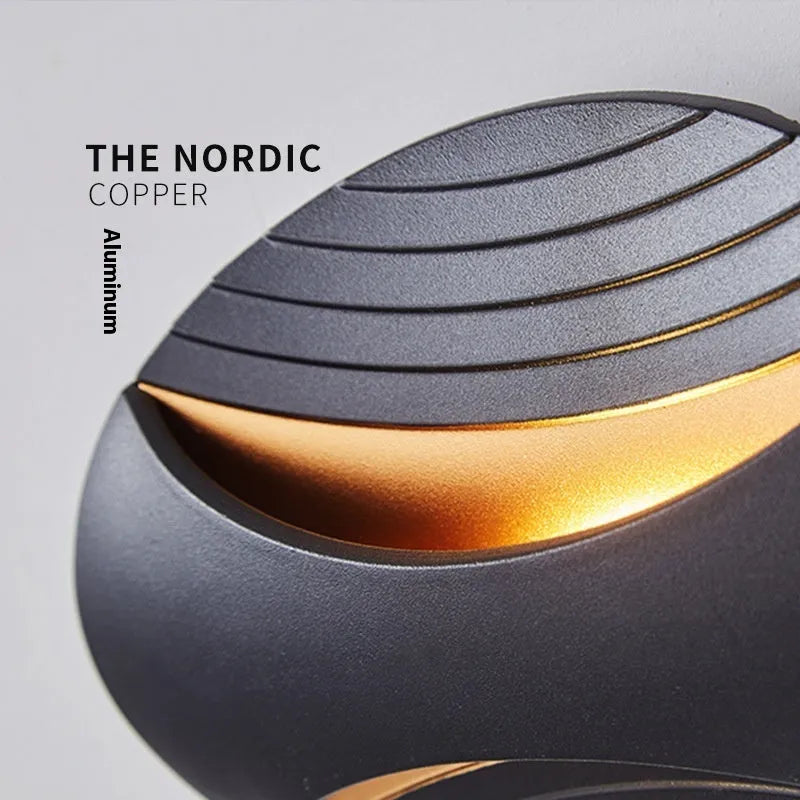 A modern aluminium wall lamp mounted beside a bed, showcasing its minimalist design.