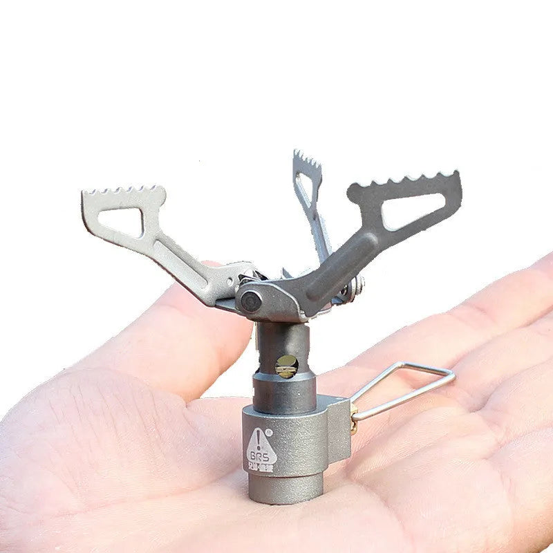 Portable mini camping gas stove in silver metal, 25g weight, for outdoor propane cooking