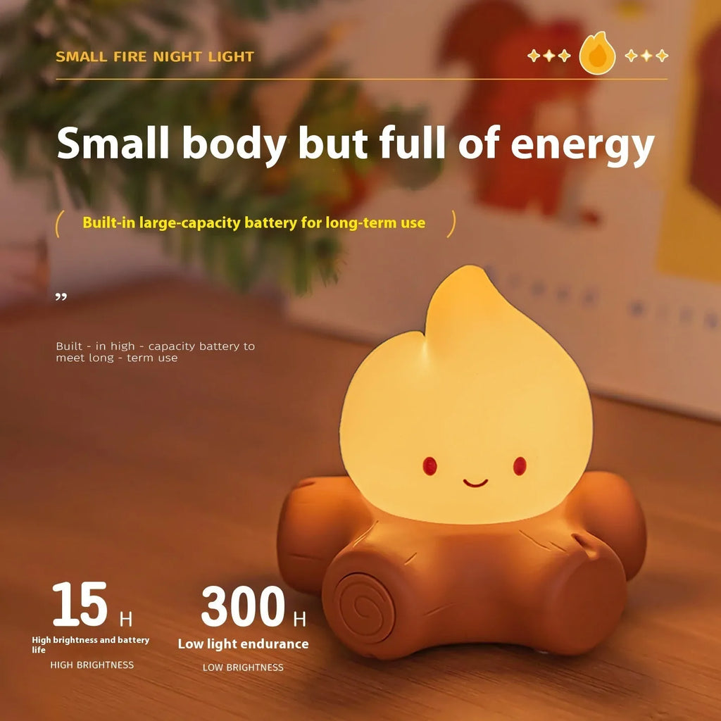 Silicone cartoon fire pile shaped night lamp with yellow glow, shown next to a USB charging cable.