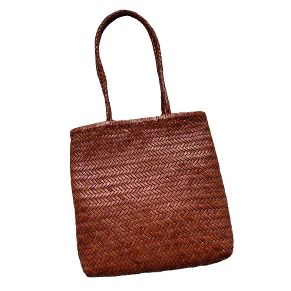 Brown handmade woven leather tote bag with a front pocket and polyester lining.