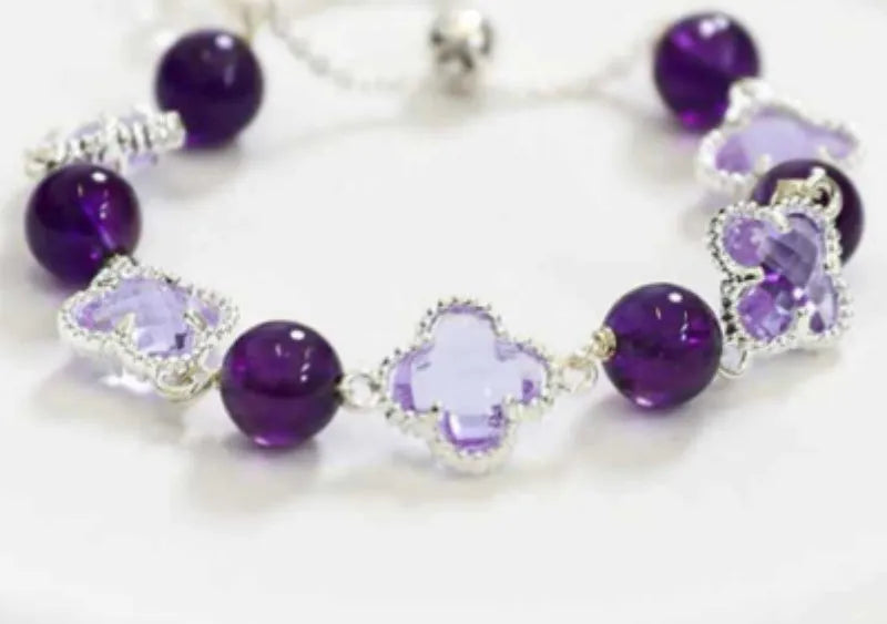 Women's artificial amethyst four-leaf clover bracelet with pearl accents on U-shaped electroplated chain.