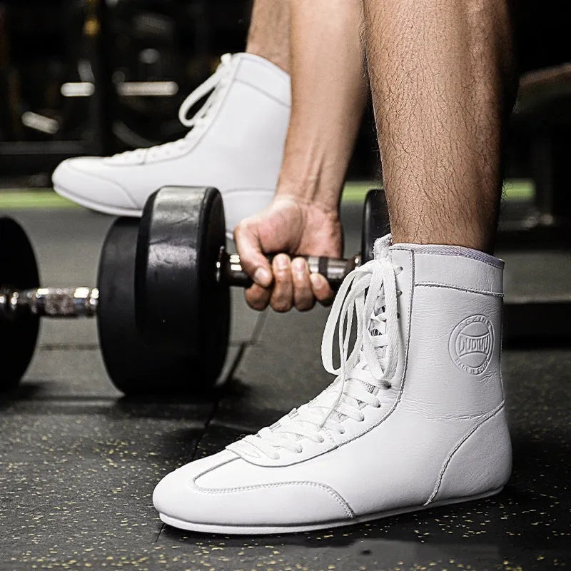 Professional black and gold mesh boxing shoes with non-slip soles for indoor training.