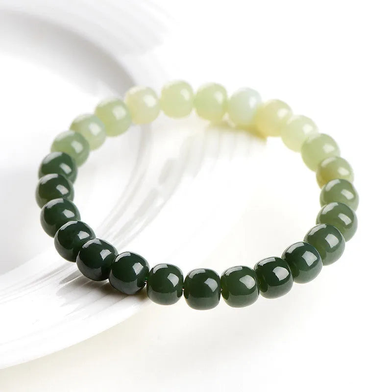 Natural Hetian jade bracelet showing gradient clear to water colour beads on elastic cord
