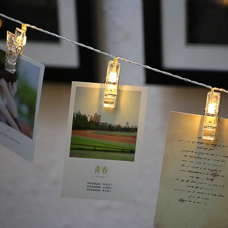 LED decorative light string with white heart-shaped clips spaced along its length, illuminated with warm white LEDs.