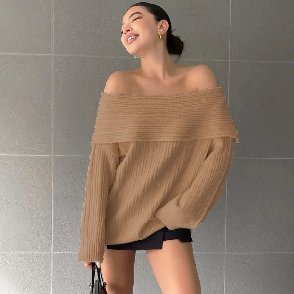 A woman's loose-fitting, long-sleeved pullover sweater in acrylic fibre, shown on a hanger.