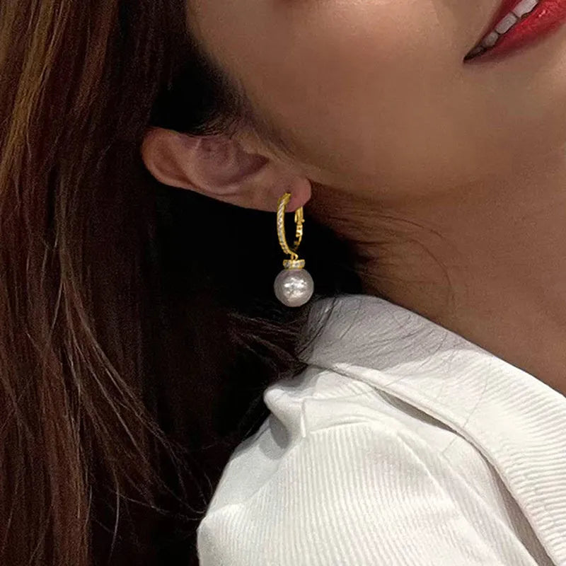 Yellow gold tone geometric earrings with imitation pearl and zircon inlay, round and ring design, one pair.