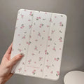Transparent floral tri-fold iPad case showing magnetic stand function and clear polycarbonate construction