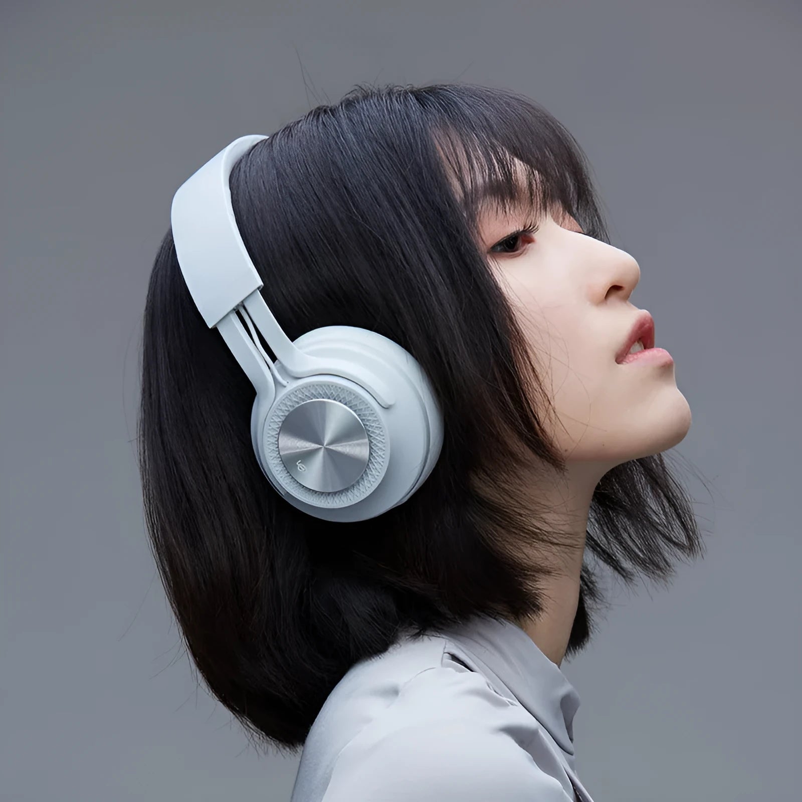 A red wireless Bluetooth sports headset with over-ear design on a grey background.