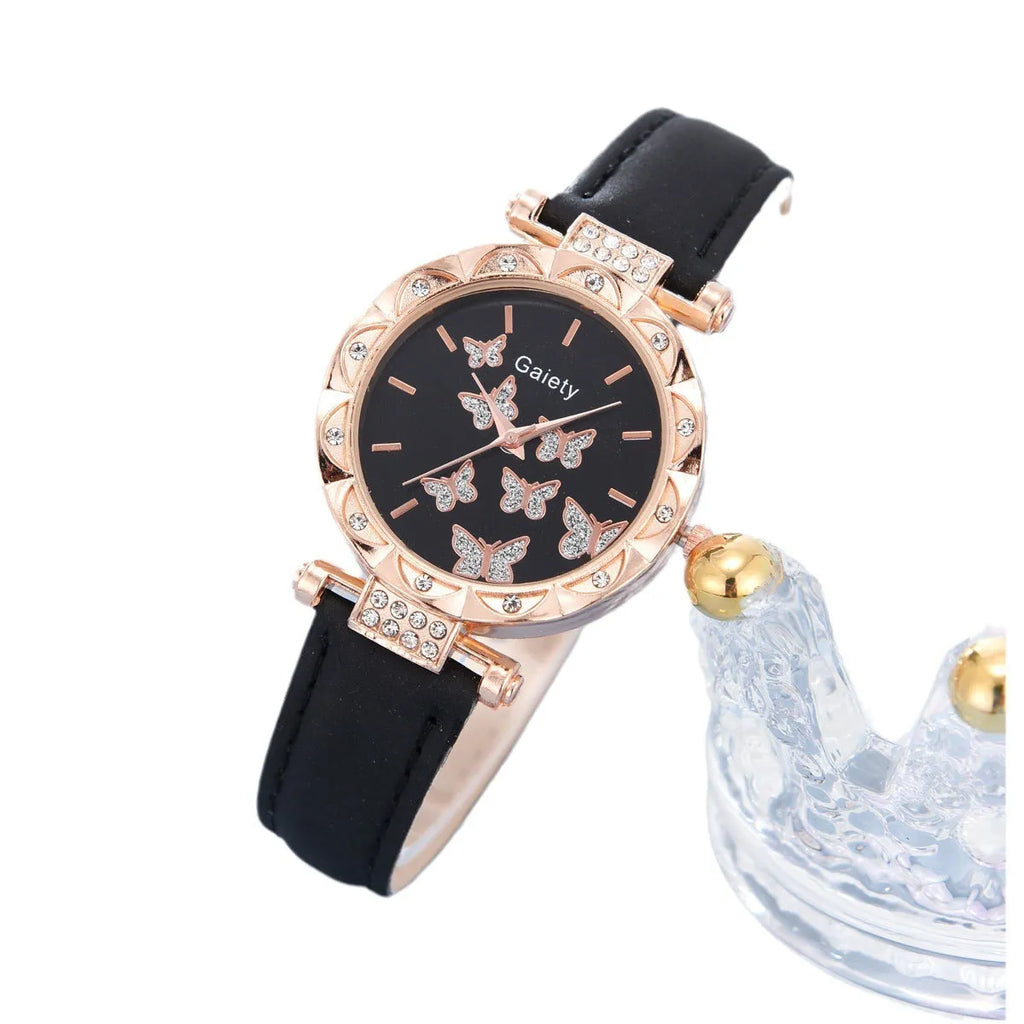 Women's butterfly quartz belt watch with imitation leather strap and pin buckle, available in black brown pink red beige