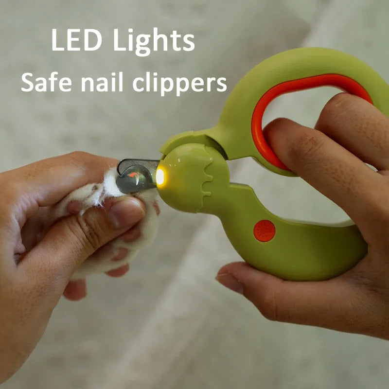 Donuts Lovely blue pet nail clippers with LED light on, showing non-slip handles and stainless steel blade.