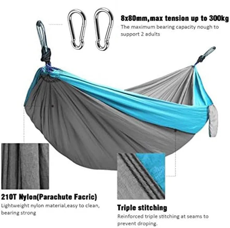 Blue nylon parachute cloth outdoor hammock hung between trees, showing its length and width.