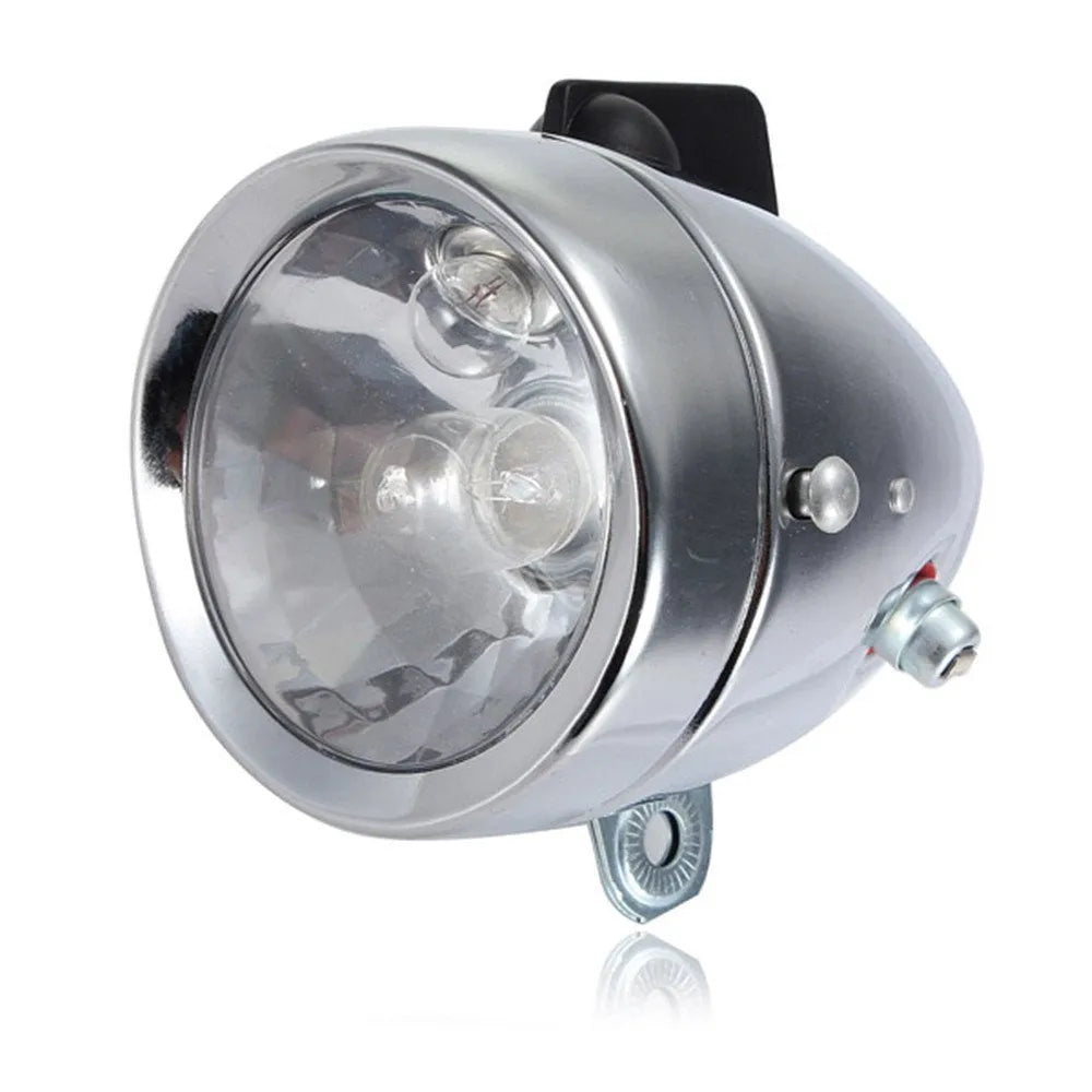 Silver bicycle dynamo generator light kit mounted on a bike frame for friction-powered 12V headlight and tail light
