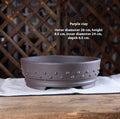 Chinese style indoor tabletop drum nail purple clay ceramic flowerpot with breathable design in purple clay colour on a wooden surface
