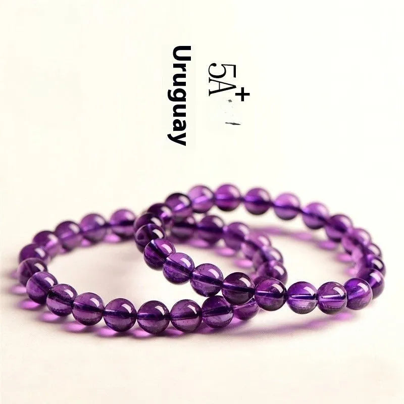 Natural amethyst scattered beads Uruguay bracelet in polished crystal on a white background.