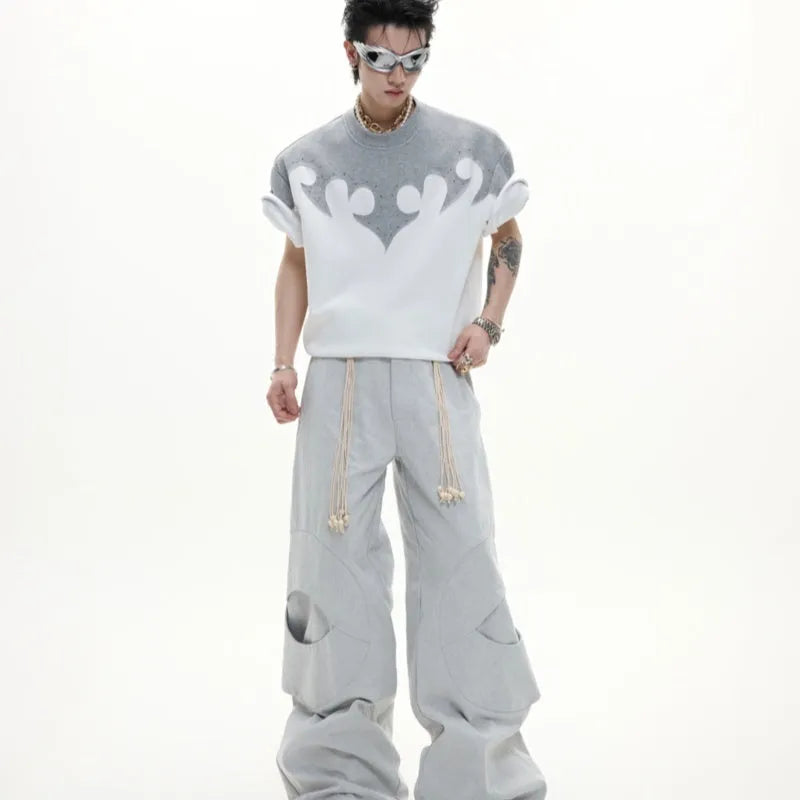 Men's grey cotton T-shirt with burnt flower stitching and rhinestone details on the front, showing loose fit and drop-shoulder sleeves.