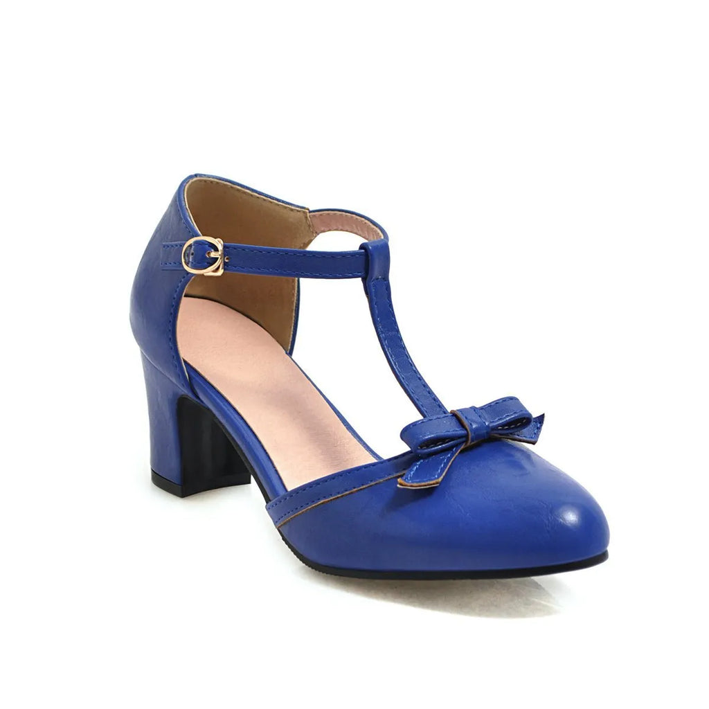 Women's apricot coloured sandals with a chunky heel, buckle strap, and bow detail on the toe.