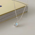 Silver women's necklace with round ornamental stone geometric pendant on a curb chain.