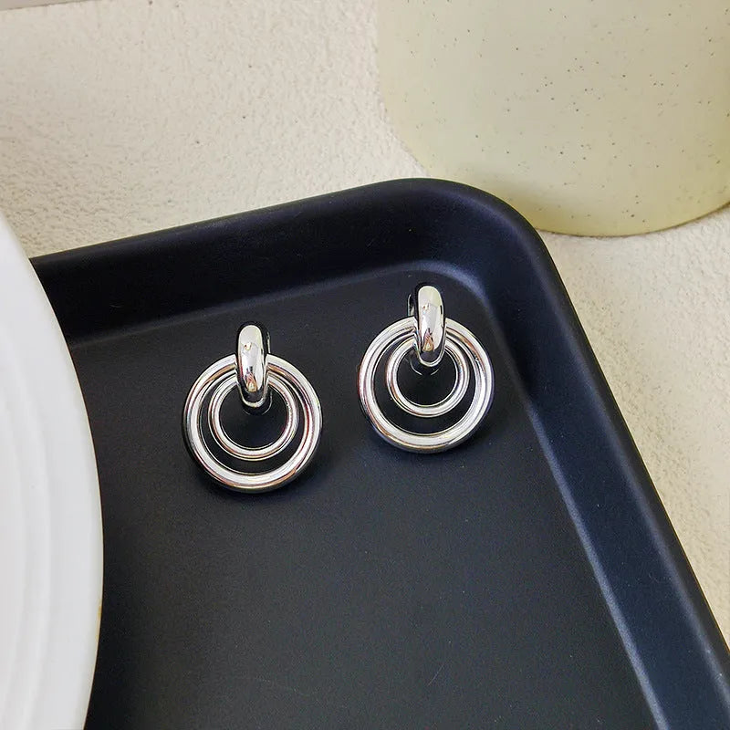 Geometric round ring earrings for women with electroplated gold or silver finishes and irregular contemporary design