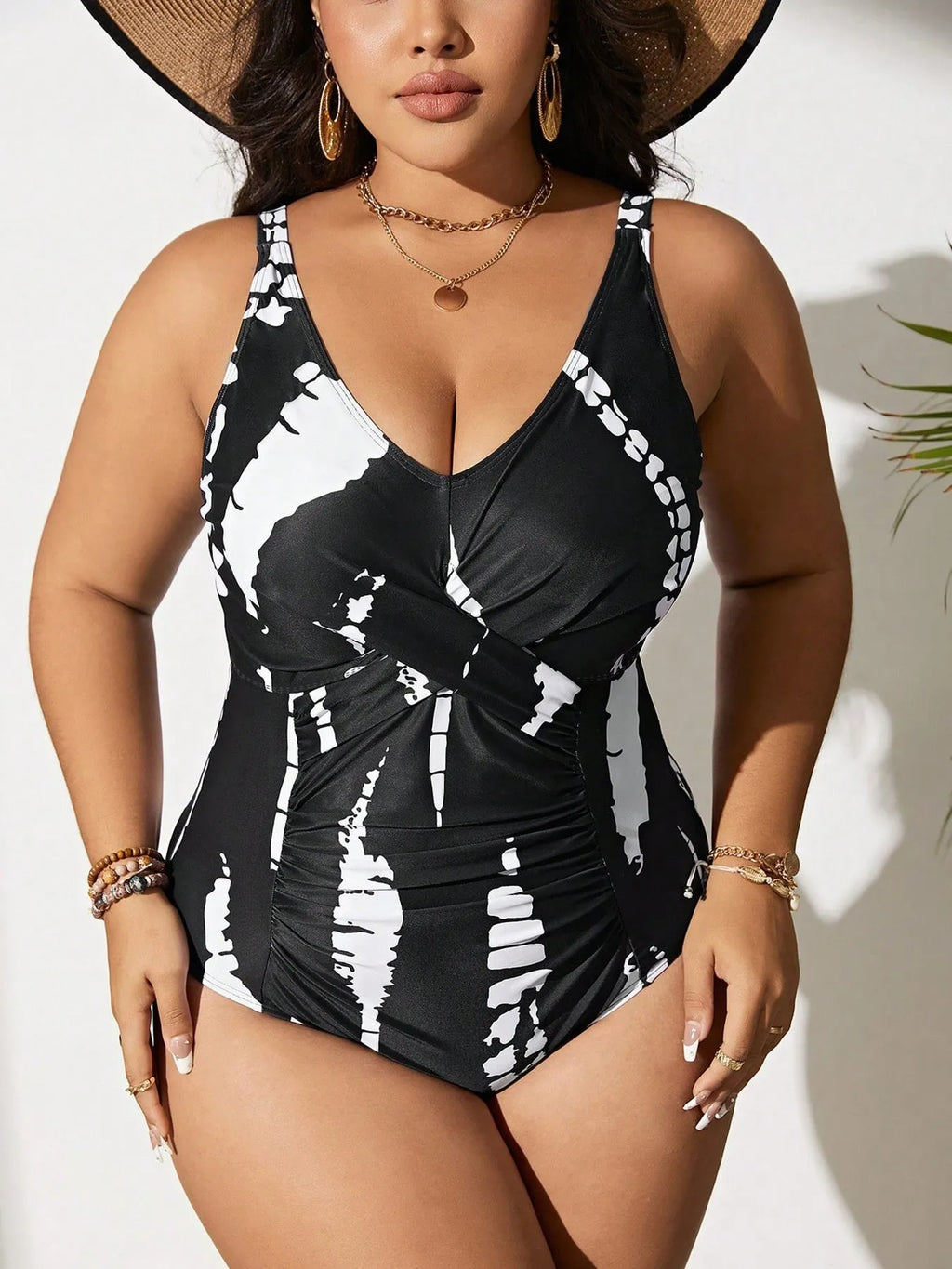 Black Siamese colour matching one-piece swimsuit on a hanger, showing sleeveless design.