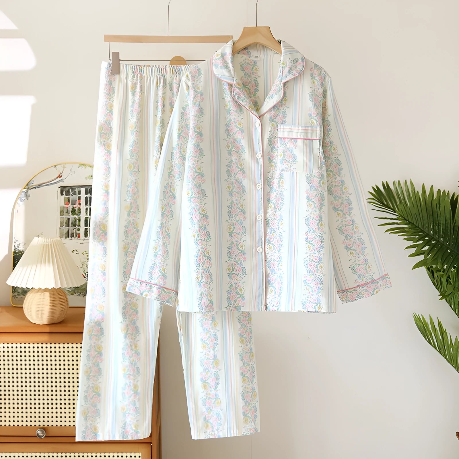 Women's red fruit print cotton gauze long-sleeved top and trousers two-piece loungewear set laid flat.