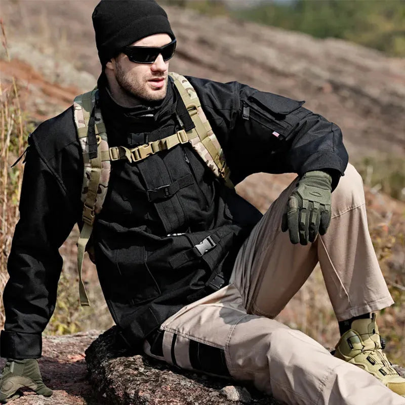 Men's multi-pocket water repellent outdoor trousers in army green, front view showing pockets and fabric texture
