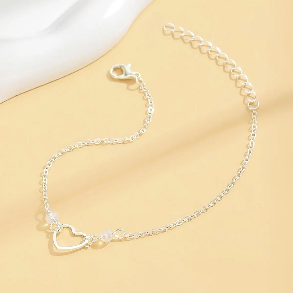 Women's geometric anklet with heart pendant on adjustable alloy chain in gold or silver finish