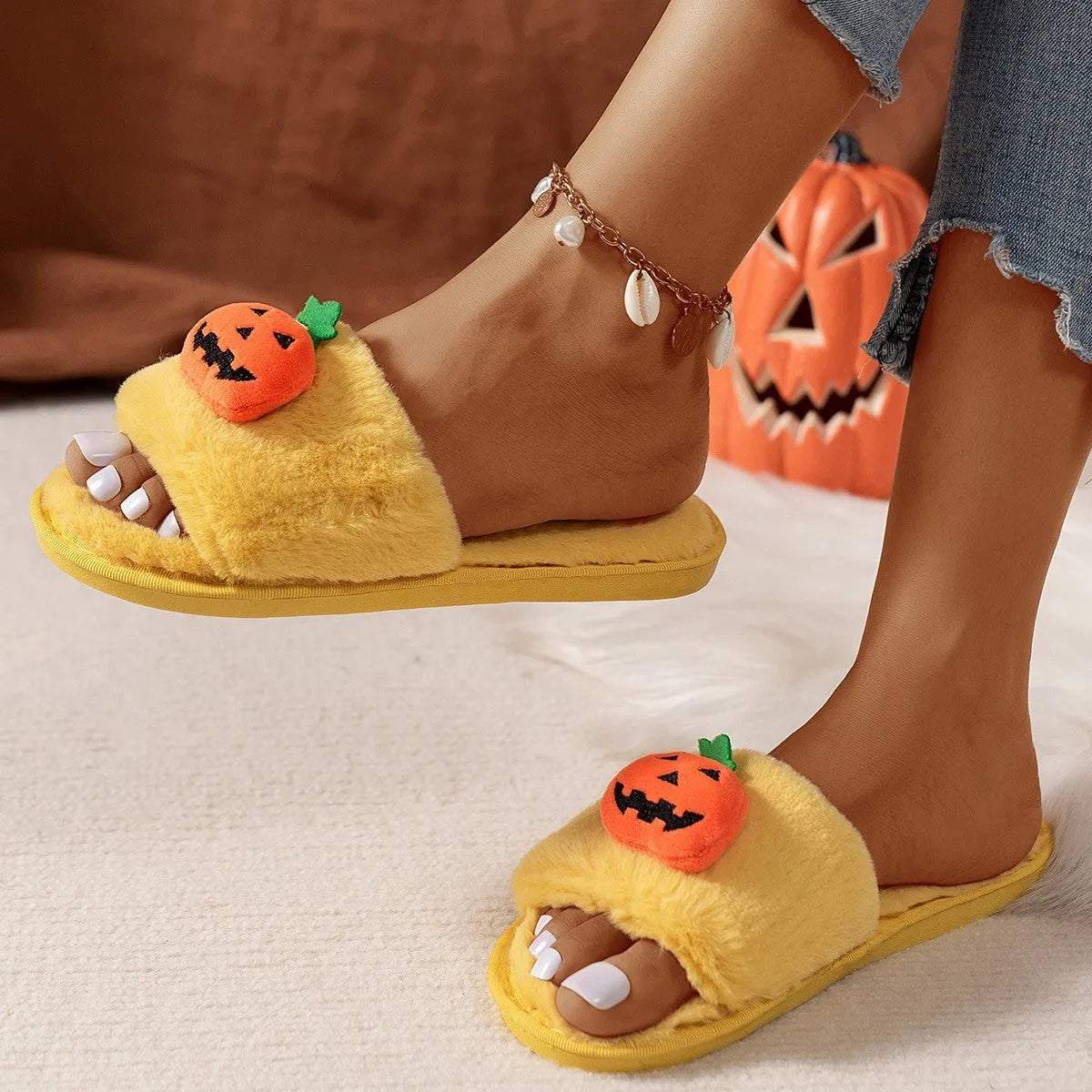 Pumpkin-themed plush slippers with open toe design and anti-slip PVC soles in white and yellow colour options