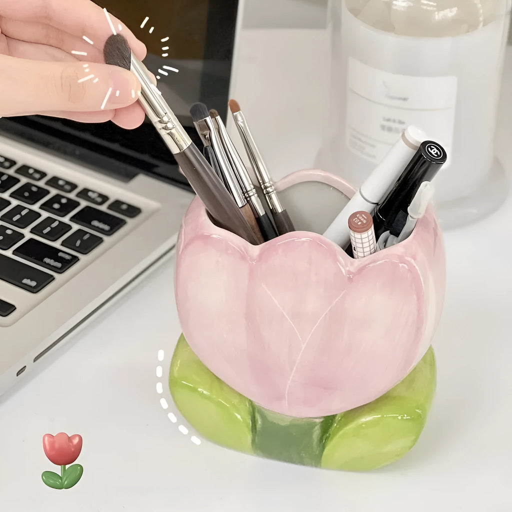 Ceramic flower pen holder in a floral pattern, showing its size next to pens for scale.