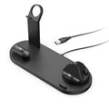 Black wireless charging stand holding a mobile phone and a smartwatch on a desk.