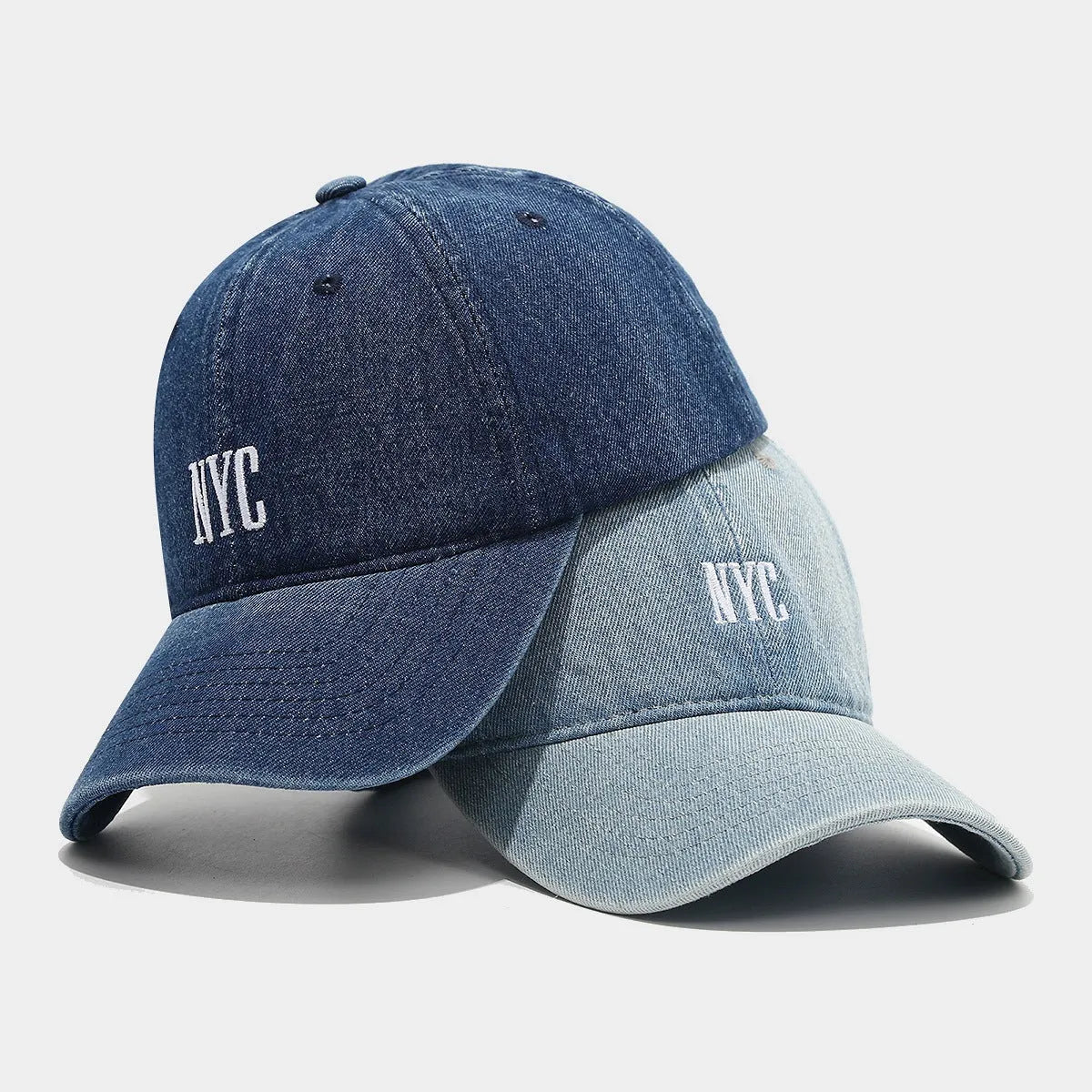 Retro style denim peaked cap with a large alphabet letter on the front, shown in light blue.