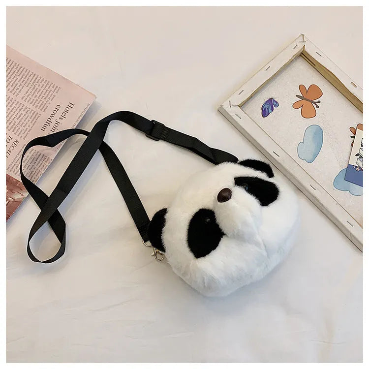 Soft plush cylindrical panda head crossbody bag with a shoulder strap.