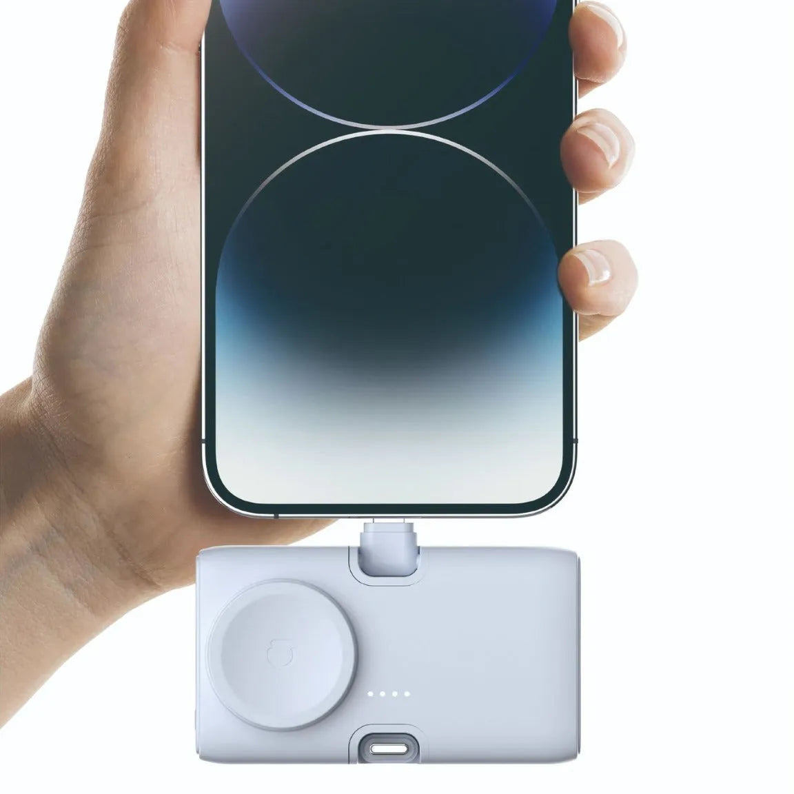 Compact white wireless power bank with 5000mAh capacity, shown next to a smartphone for scale.
