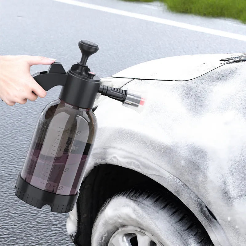 Black handheld 2L foam watering can sprayer with pump handle and two nozzles.