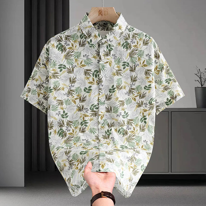 Men's short sleeve cotton shirt with colourful Hawaiian floral print, cardigan style, on a hanger.