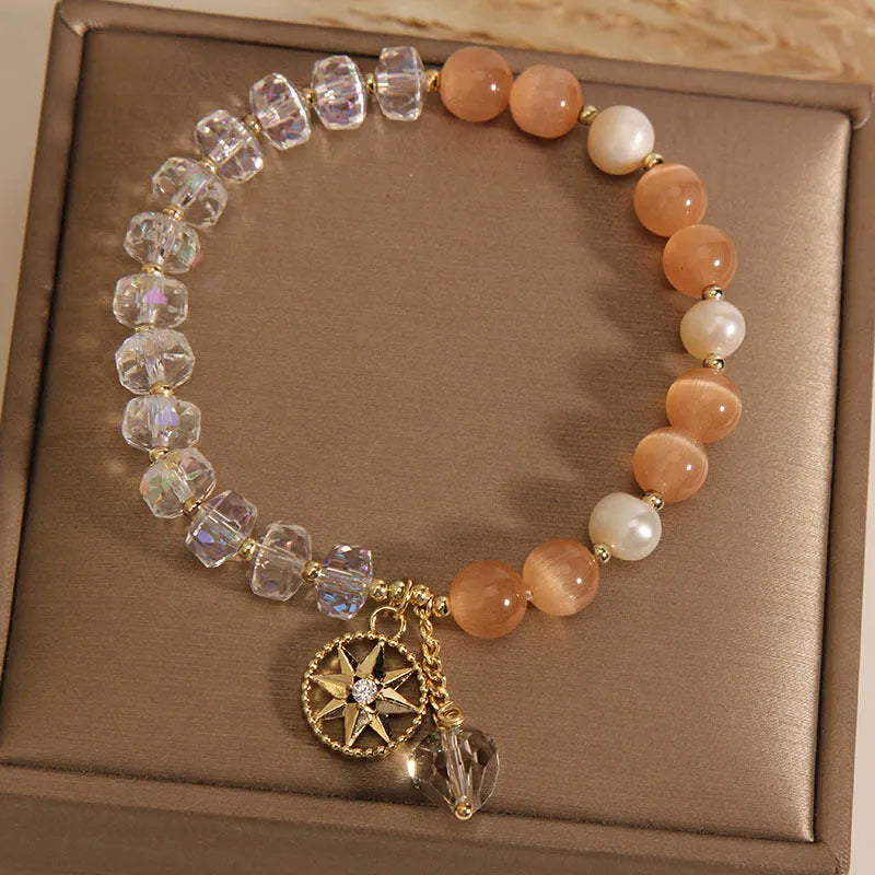 Orange opal crystal bracelet with gold-plated eight awn star design and artificial gemstone inlay