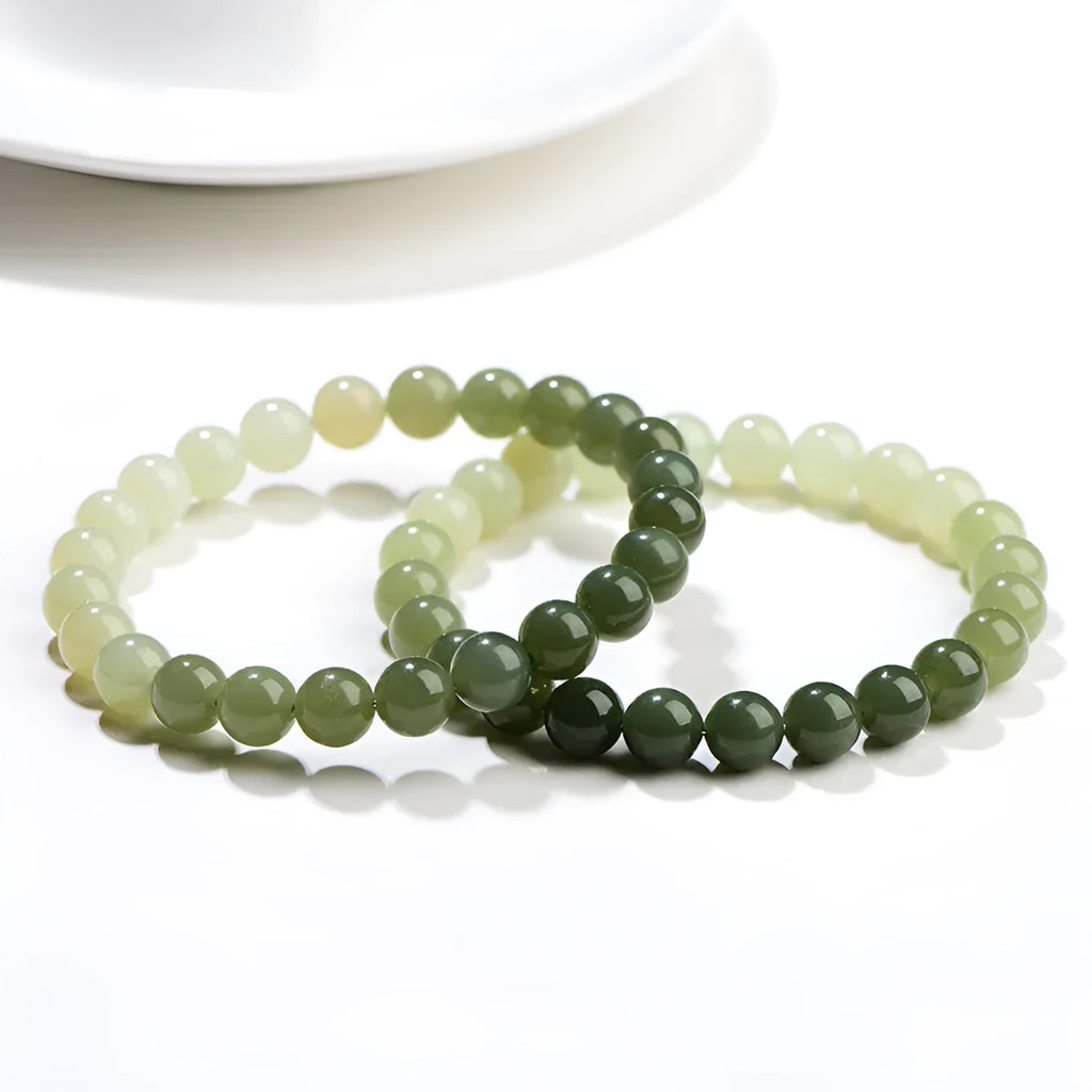 Natural clear water Hetian jade ball bracelet showing gradient jade beads in round or barrel shapes