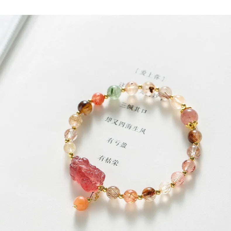 Women's strawberry quartz and copper bracelet with Pixiu charm, pearl, and dopamine crystals.
