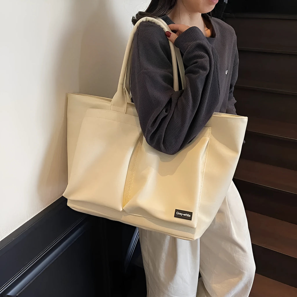 Lightweight PU shoulder bag in solid colour with ventilation features and 20-35L capacity