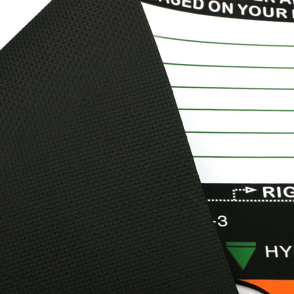 Black neoprene golf swing training pad with alignment markings on a green artificial turf surface.