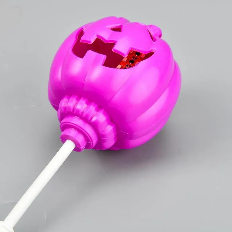 Plastic pumpkin-shaped decorative lamp with a USB cable, glowing either yellow or purple.